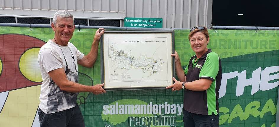 RARE FIND: Julie Gallagher from Salamander Bay Recycling presents the map found by staff among donations to the centre to Tomaree Museum Association chair Ian Farnsworth. Picture: Supplied