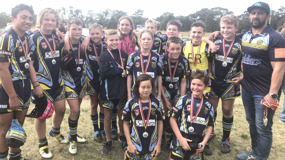 PREMIERS: Nelson Bay Junior Rugby League Club's under-12 premiers with coach Richie Kinkaid.