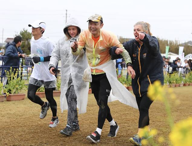 HELPING HAND: Erin Brinkley (left) and Angela McMillan assisting an exhausted Minoru Wada in the marathon. Picture: Supplied