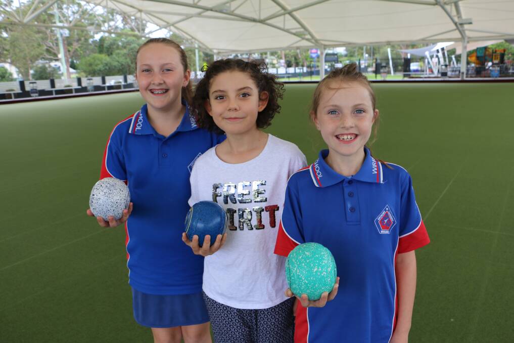 LET'S PLAY: Siblings Reegan Clarke, aged 10, and Kobie Clarke, 8, with friend Nyah Eissa, 9, get a taste of lawn bowls at Soldiers Point Bowling Club.