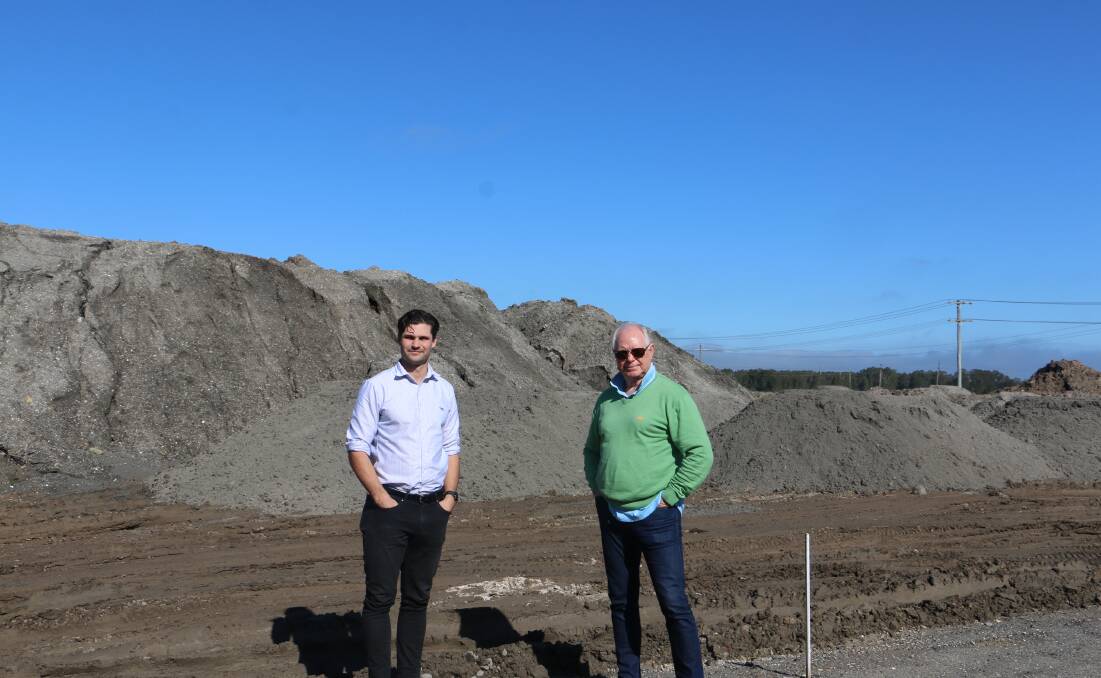 INVESTMENT: Wayne Fussell (right) with Oli McCarthy, Yukon project manager, at the development site on the corner of Lavis Lane and Nelson Bay Road at Williamtown.