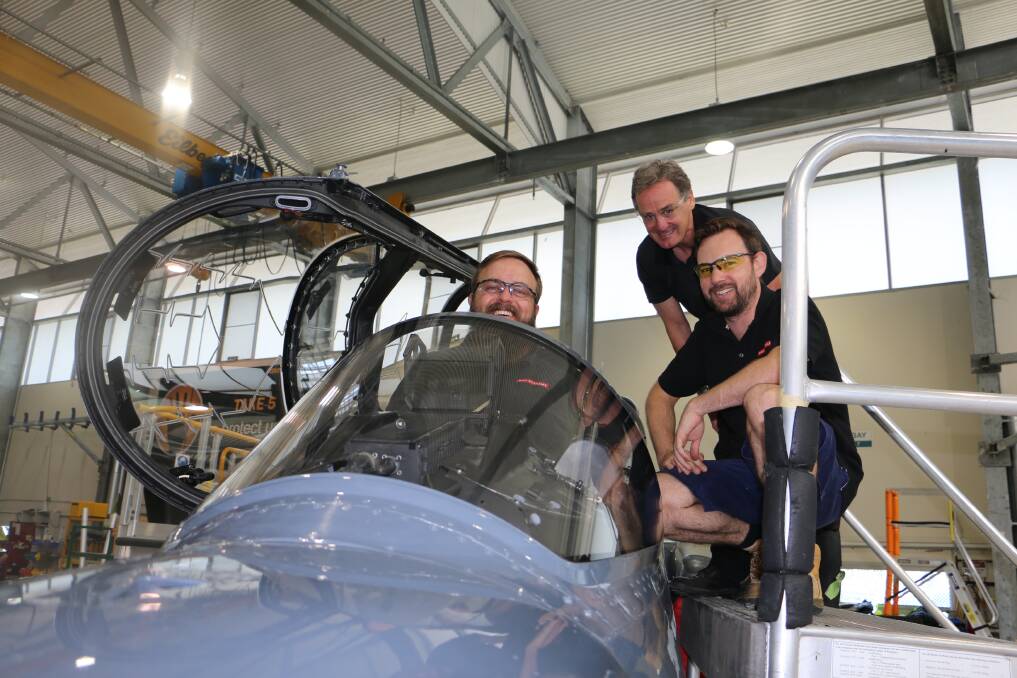 END OF THE LINE: Team Leader Steve Storer (in cockpit) with integration manager Ken Downey (centre) and avioncis technician Chris Horold in a Hawk jet.