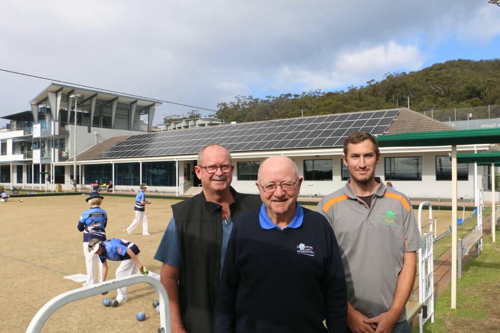 ENERGY SAVER: Board chairman Max Harman (centre) with hon. secretary Damien Kroek and On Generation's Kent England in front of the solar panels being installed at Nelson Bay Bowling Club.