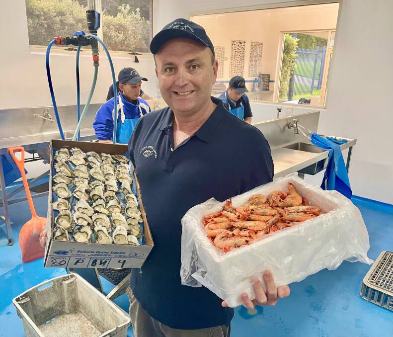 CHRISTMAS RUSH: Freshly farmed oysters and prawns are available at Holberts for many Port Stephens Christmas celebrations this year. Pictured is Guy Holbert. Picture: Supplied