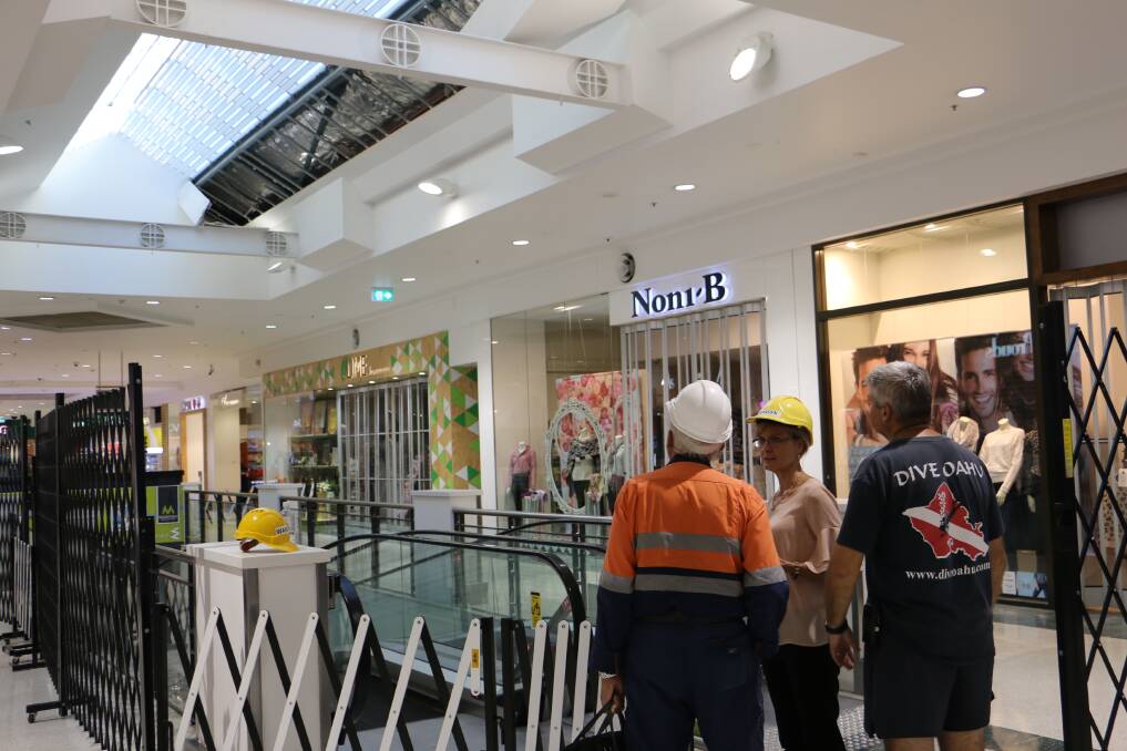 SAFETY FIRST: Raymond Terrace Marketplace staff meet with an engineer to inspect the damage of the cracked ceiling.