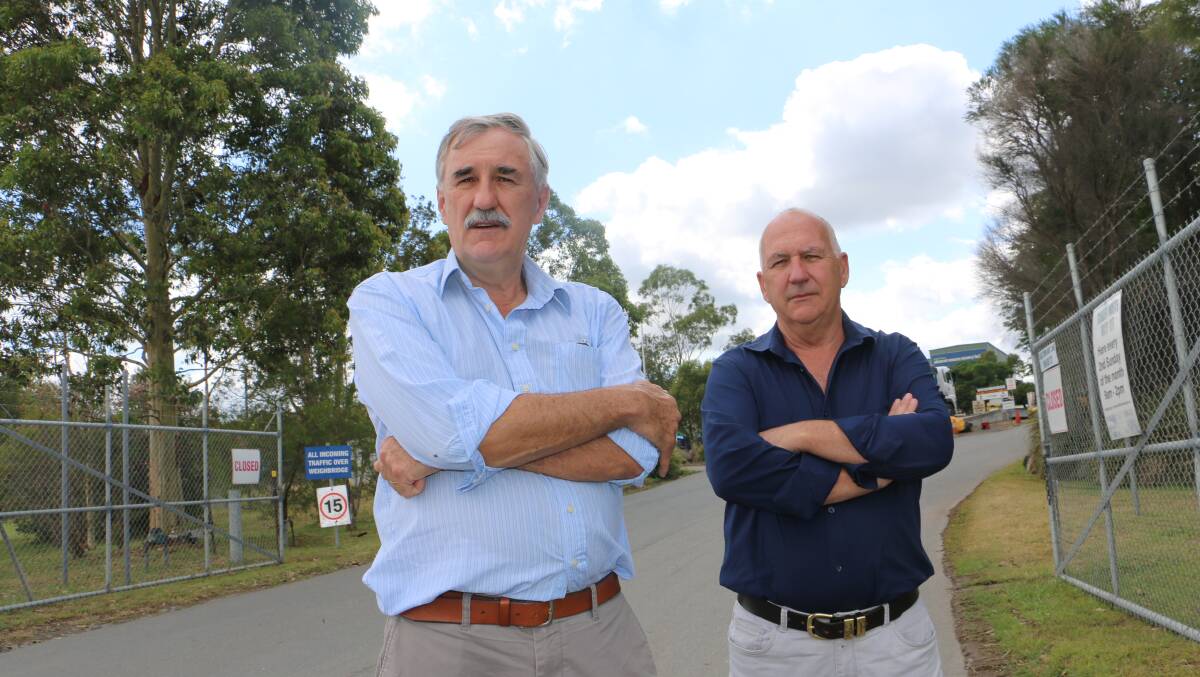 NOT HAPPY: Port Stephens councillors Steve Tucker and Paul Le Mottee in front of the Newline Road waste management facility in Raymond Terrace.