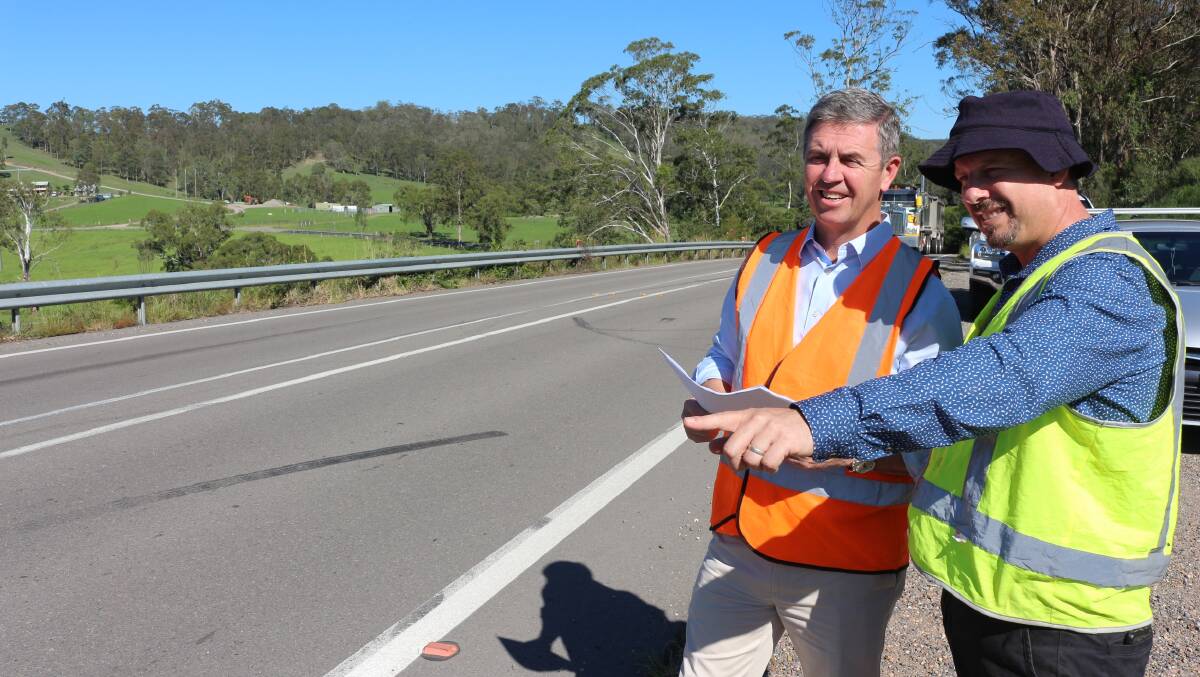 Federal Member for Lyne Dr David Gillespie  inspects a road with Port Stephens Council’s capital works section manager Phil Miles.