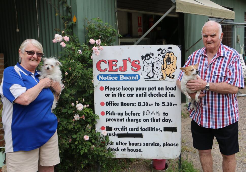 PET LOVERS: Sue and John Summers with pet dogs Tina and Peggy at the Bobs Farm boarding kennels property.