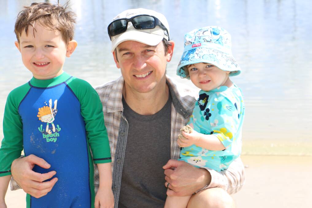 HOLIDAY TIME: Enjoying a day at Nelson Bay beach on Tuesday was Sydney visitors John Speelman with son Javier, 4, and daughter Mia, 1.