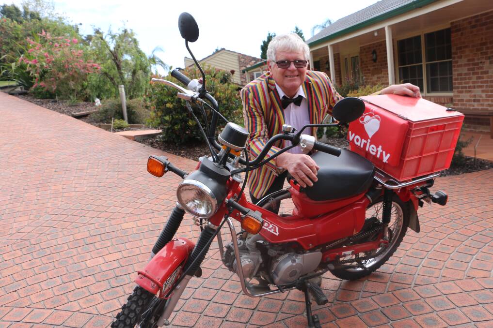 CHARITY DASH: Nelson Bay's Warrick Mathieson dressed in trademark suit with his trusty postie bike.