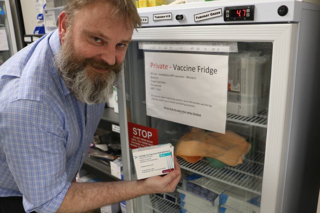 ROLLING OUT: Dr Paul Burford displays the COVID vaccine packaging and fridge at his medical clinic in Williamtown, where the vaccinations have commenced.