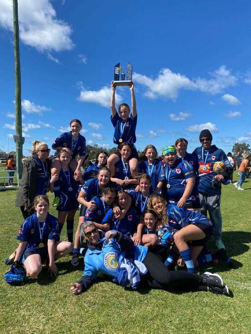 CHAMPIONS: The Raymond Terrace Rooster under 13s premiership winning team lift the trophy after last Saturday's emphatic grand final victory. Picture: Supplied