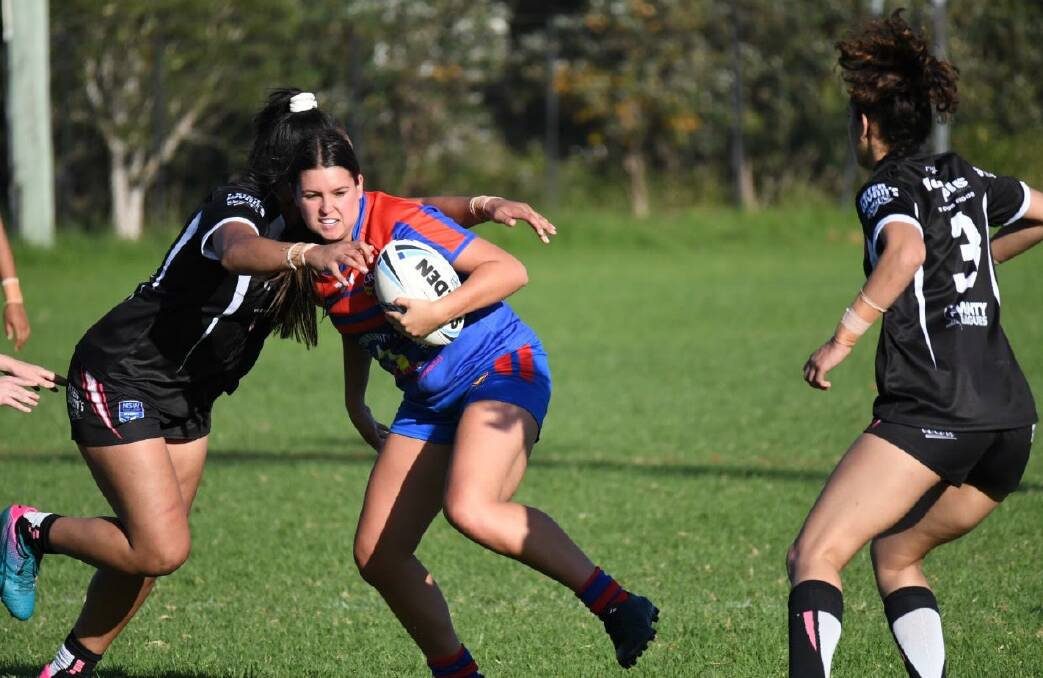 IN ACTION: Bobbi Law in her Newcastle outfit takes the ball up in a recent CRL match.