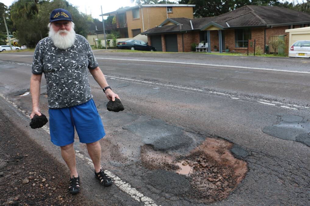 POTHOLE: Graeme Tobin with debris from one of the potholes on Lemon Tree Passage Road, which has subsequently been filled by council.