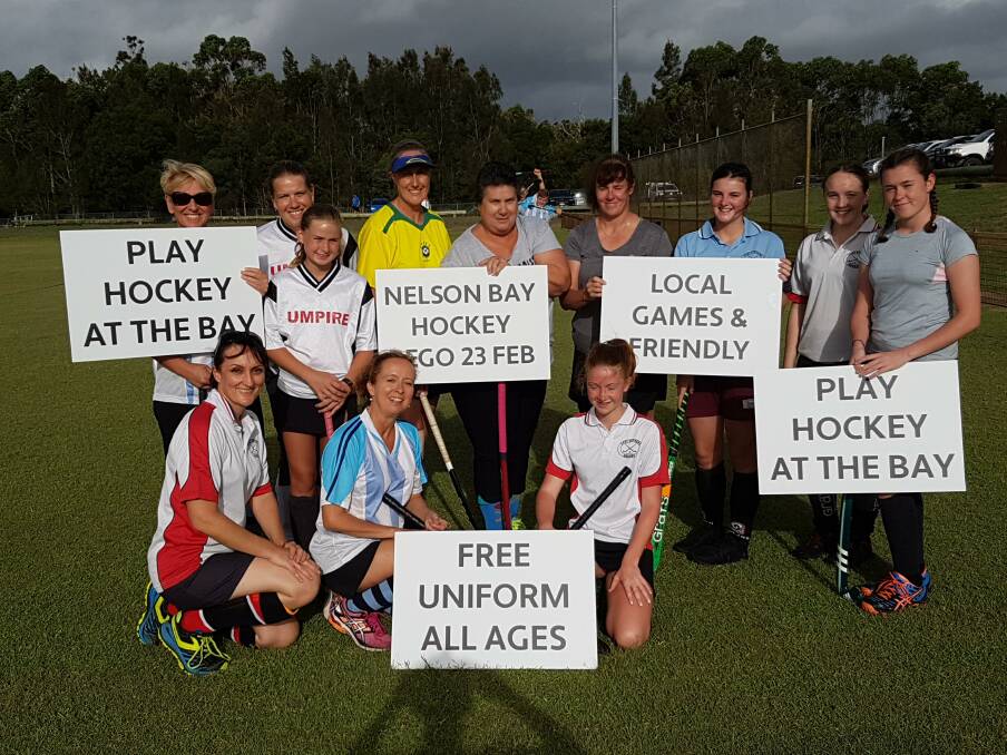 FAMILY SPORT: Members of the Nelson Bay Hockey Club women's squad advertising the family deals available for new players.