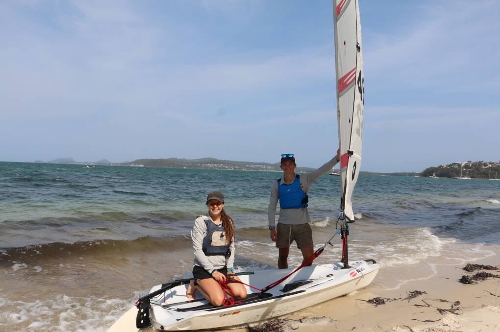 SAILING ON: Port Stephens sailing club instructors Sohpie Cottam, 20, and Marcus Busch, 17, in an open Bic boat on Salamander Bay last December.