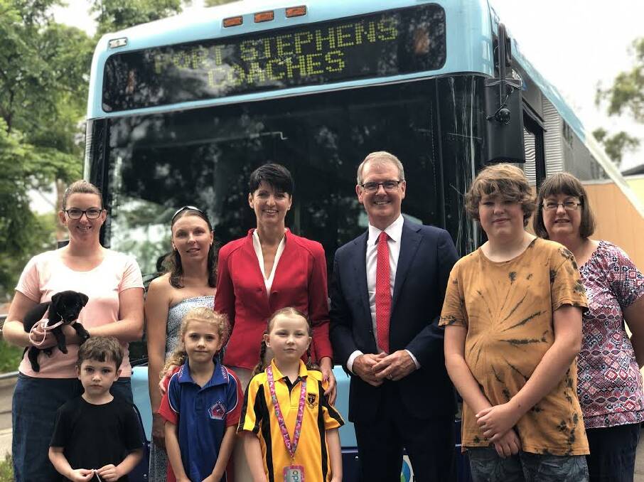 FREE RIDE: Labor Leader Michael Daley and Port MP Kate Washington (centre) with Holly McKew (nursing puppy Jess) and children Anna, 6, and Ryan, 4, Leah Callaghan with daughter Ashley Hitchcock, 6, and Susan Patten with son Nick, 13.