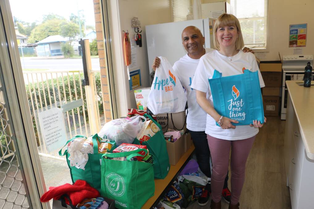 FOOD PACKAGES: All Saints Anglican Church pastors Kesh and Catherine Govan with some of the food packages which are distributed by Hope Cottage volunteers to those in need in Port Stephens.