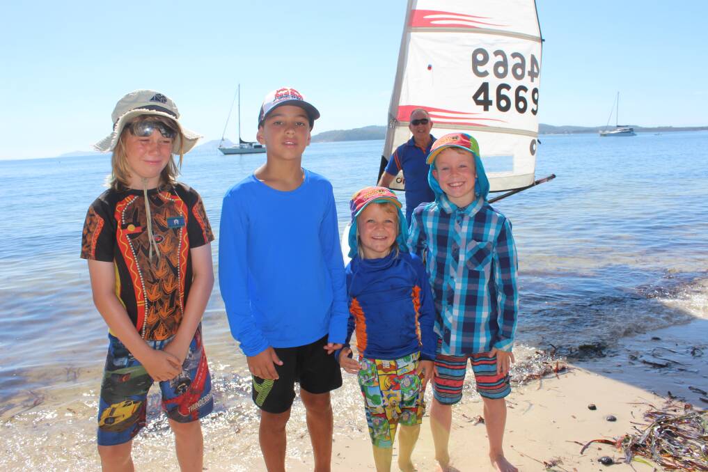 YOUNG SAILORS: Siblings Felix King-Schmidt, aged 9, Otis, 7, and Spike, 5, with Kaique Barbosa, 11, and Port Stephens Sailing club president Dennis Hume at Salamander Bay.