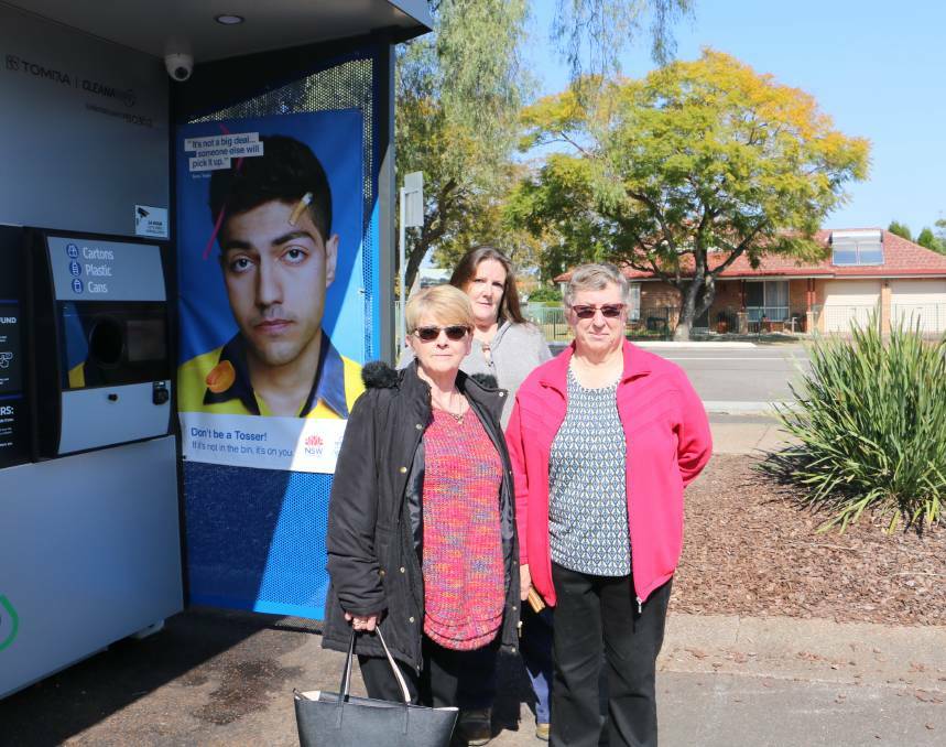 FED UP: Glenelg Street residents Cheryle Marshall, Nina Horvath and Julie Robertson in front of the Terrace Central Return and Earn reverse vending machine.