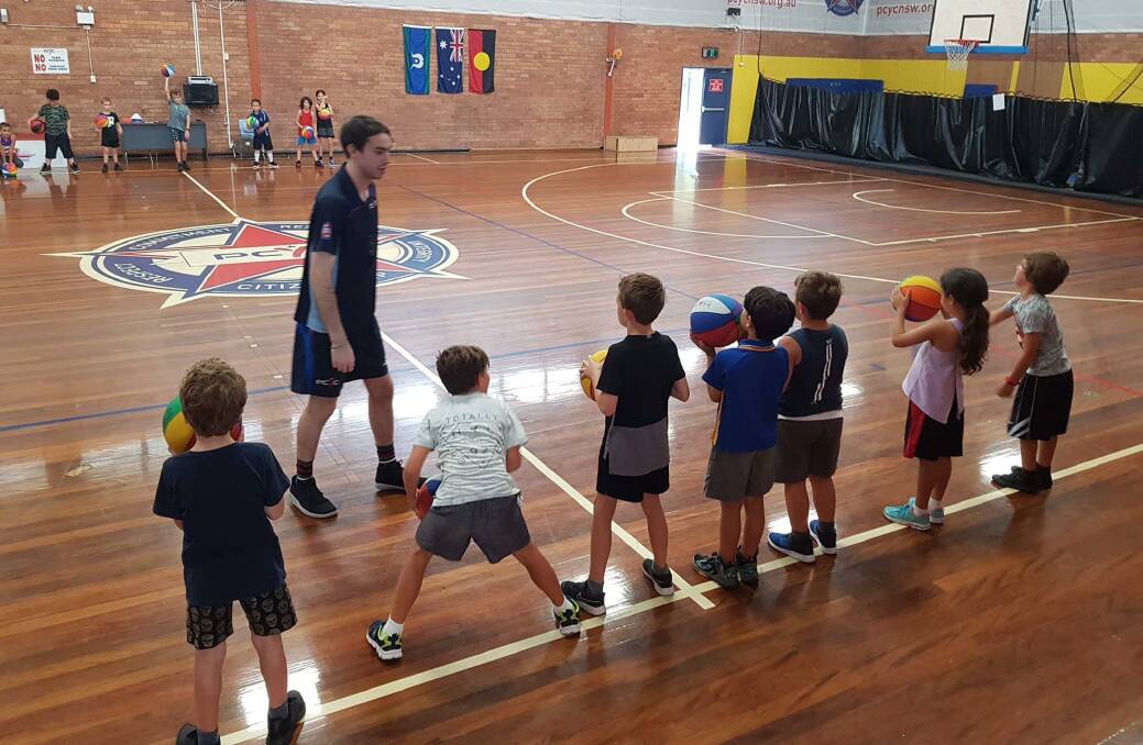 BACK IN ACTION: PCYC basketball coach Dan Howard going through some training drills with young basketball members at the Nelson Bay-based PCYC club. Picture: Supplied