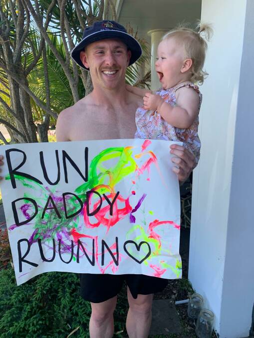 SUPPORT: Kurt Aldridge with his number one fan, daughter Isla, and the sign she helped design. Picture: Supplied