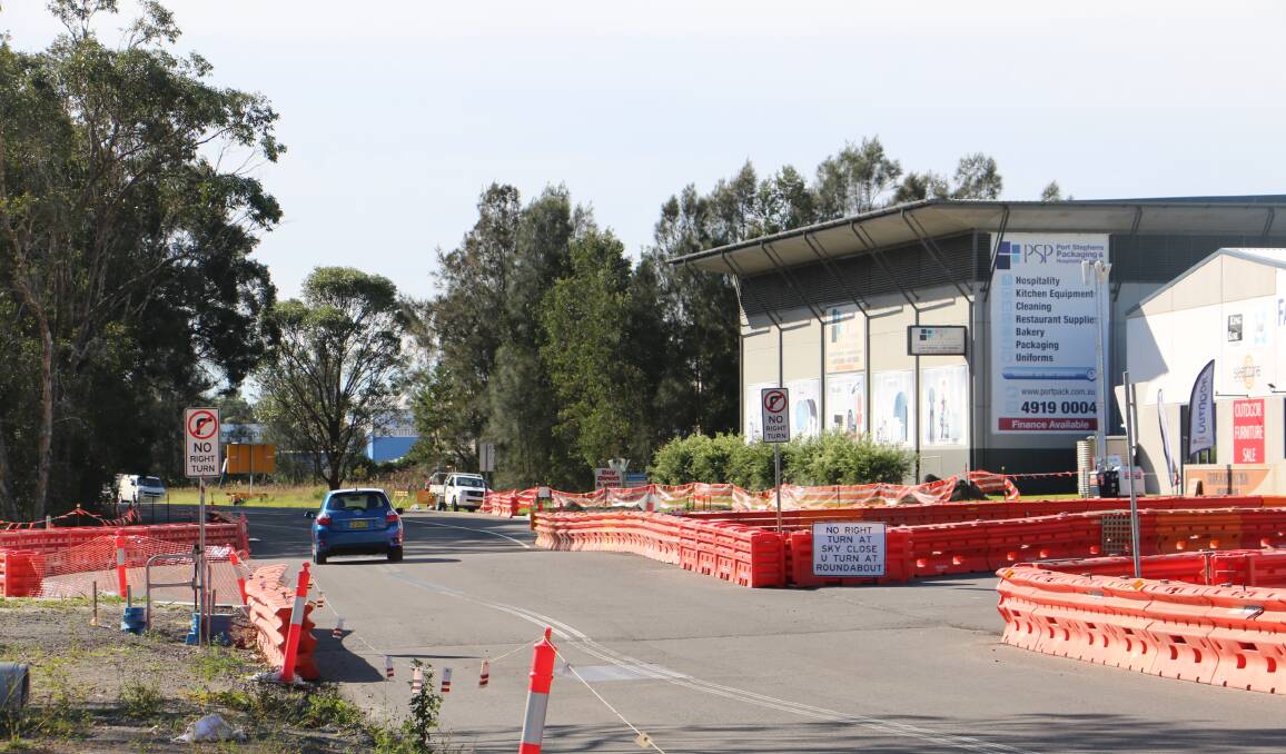 NO RIGHT TURN: The sign and roadworks at the intersection of Port Stephens Drive and Sky Close which requires motorists to perform a U-turn at the Bunnings roundabout to enter the estate.