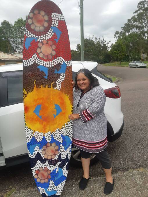 TALENT: Zona Kelly with a painted surfboard used by the Men of League for a fundraiser. Picture: Supplied