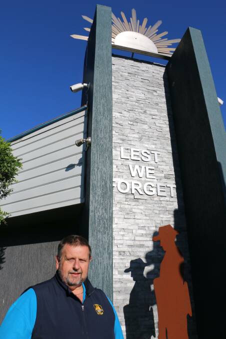 NEW MONUMENT: CEO Ross Parr in front of the new feature at Karuah RSL Club depicts an Australian soldier with rifle in hand under the setting sun and sign.