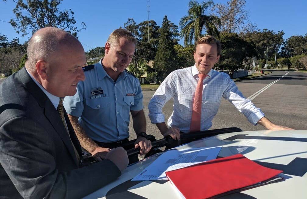 VISIT: Police minister David Elliott, Superintendent Chad Gillies and Taylor Martin MLC inspecting plans for the new Tilli station on June 25. 