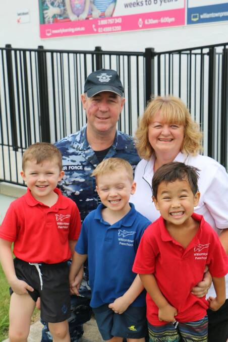 RAAF Base Williamtown Group Captain Peter Cluff and preschool director Michelle Curtin with Dominic, Saxon and Fletcher, aged 4.