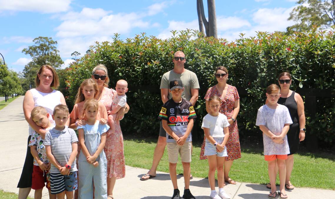 VICTORY: The Bower families - including the Magins, the Lewins, the Petrellis and the Gannons - with their children who attend St Brigid's at Raymond Terrace prior to the news of the government review.
