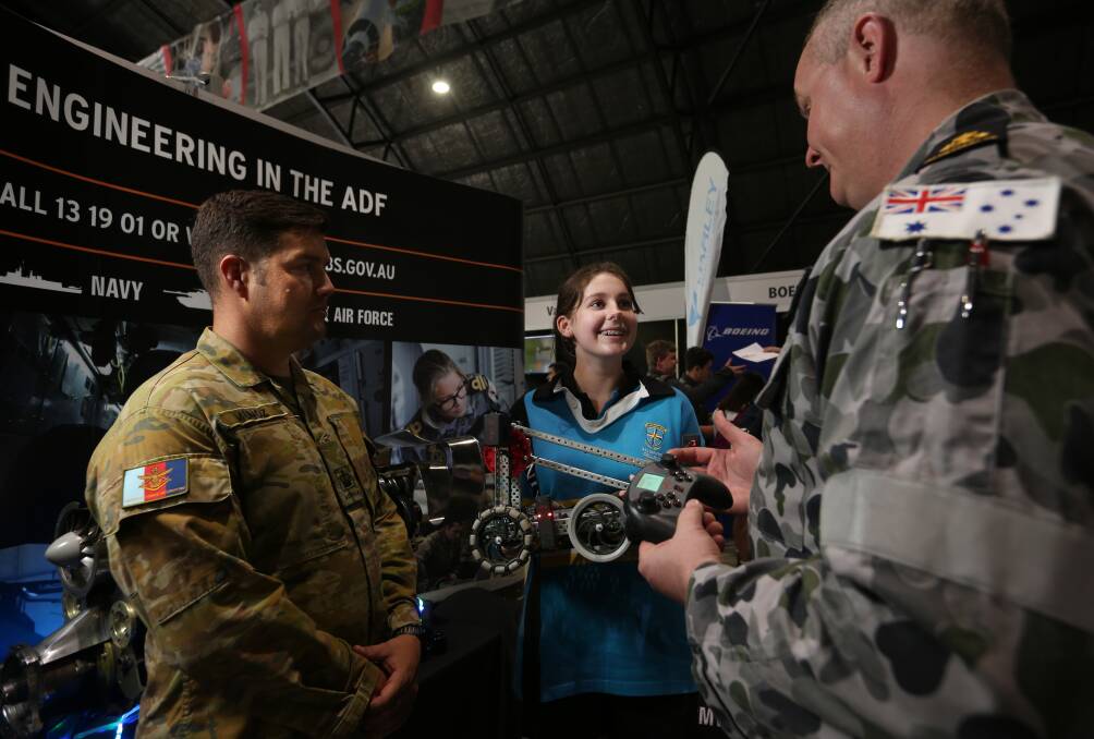 Future focused: All Saints College student Claudia Prebble with a Vex Robot, talking to aircraft technician Wilson Munoz and electronics technician Luke Porter. She takes STEM as an elective and her class will focus on rockets next term. Picture: Simone De Peak