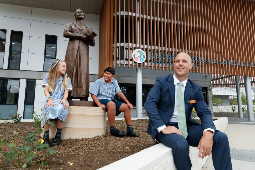 Excited: Principal Scott Donohoe with year seven students Lola Hardin and Justice Victoire. Justice, 12, said he was excited to be in the first cohort and make new friends and was open to new experiences. He said he hadn't seen another school with a striped shirt. Pictures: Max Mason-Hubers
