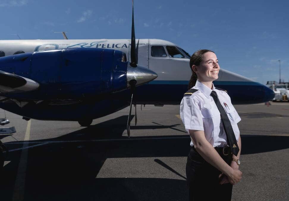 FlyPelican cadet Cassie Potts with a 19-seat turboprop at Newcastle Airport. Picture by Marina Neil 