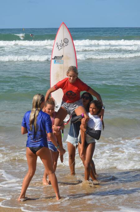 STOKED: Elle Clayton-Brown is chaired up the beach after winning the Billabong Oz Grom Cup in Coffs Harbour on Saturday.