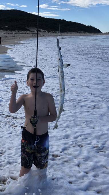 UNFORGETTABLE: Tahi Puru reels in a Long Tom at Fingal Beach on his first ever fishing trip. Photo supplied.