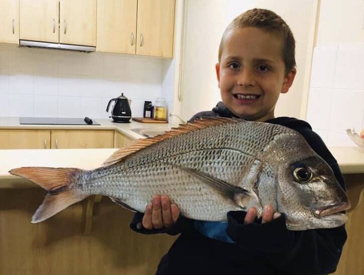 SURPRISE SNAPPER: Young Travis Thompson with a cracker snapper reeled in at Stockton Beach by Warren Thompson. Picture: supplied.