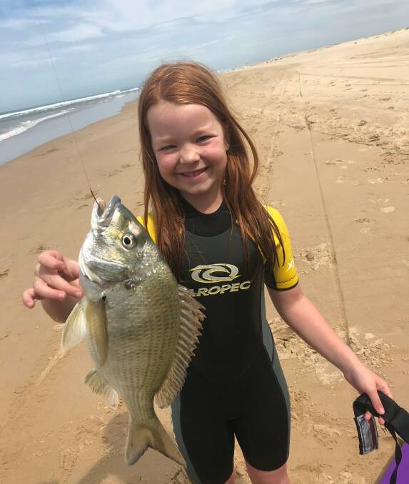 Exploring the mighty expanse: Salamander Champion eight-year-old Emily Pearson with her Stockton Beach bream caught on pipis.