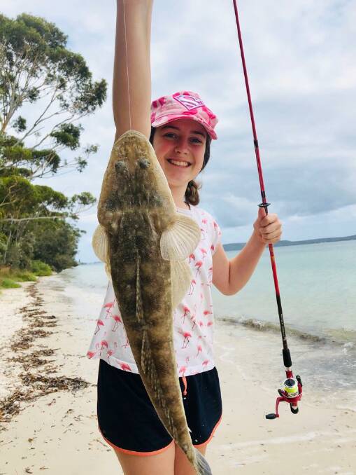 CATCH & RELEASE: Olivia Talifero at Bagnalls Beach with her thumper flathead that she thanked, kissed and released. Photo supplied. 
