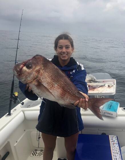 THUMPING SNAPPER: Molly Compton shows how it is done with the five kilo snapper she pulled in near Broughton Island. Picture: Supplied.