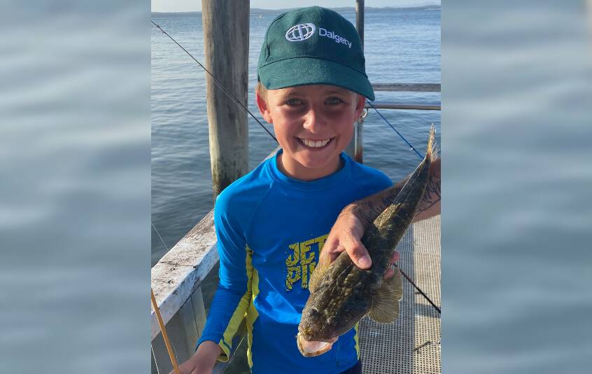 EXCITEMENT: Eight-year-old Fergus Houston from Wombat, NSW with his first fish caught while on holidays at his grandparents' home in Fingal. Picture: supplied.