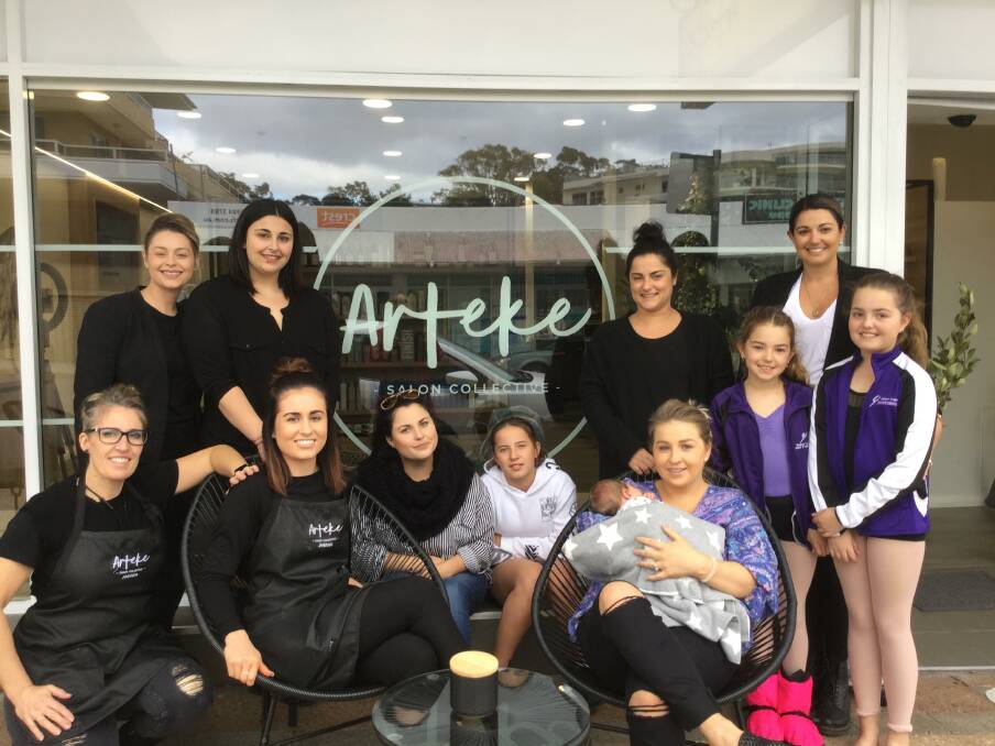 Amanda Boone (bottom left) with the Arteke Salon Collective family of stylists and apprentices in Nelson Bay.