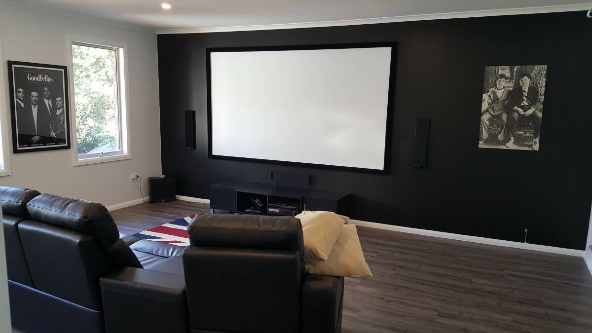 After: The newly renovated media room offers a comfortable space with the perfect balance of visual and audio impact.