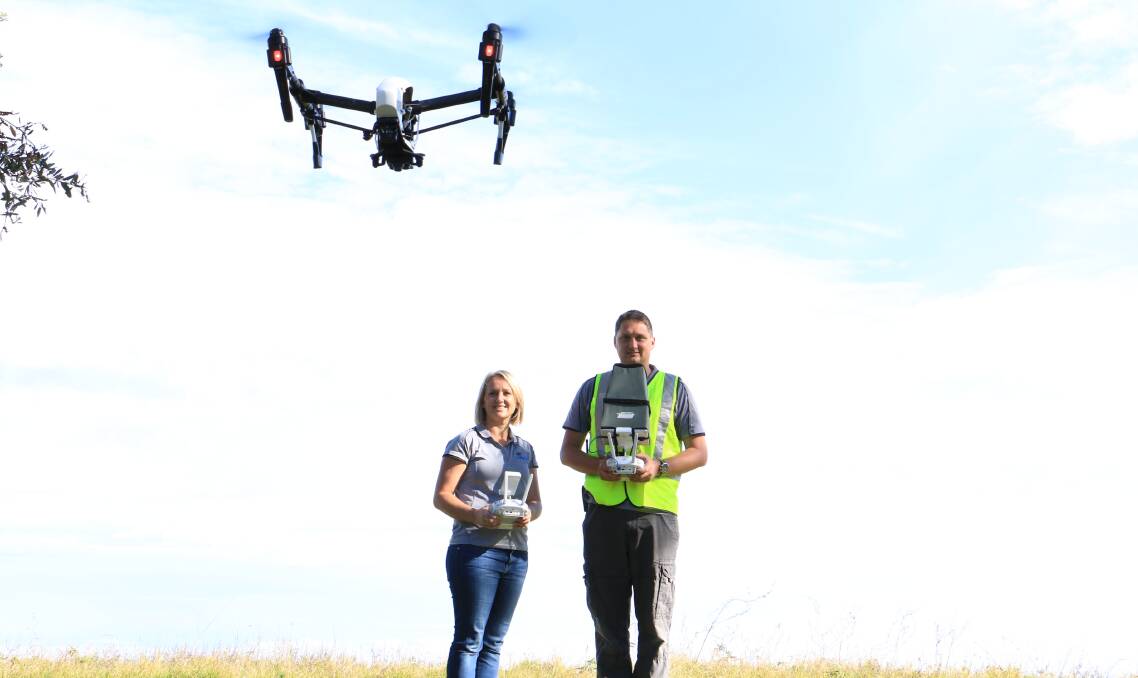FLY ZONE: Jackie Dujmovic and husband Mark, pictured at Soldiers Point, own and operate the Port Stephens-based drone business Hover UAV. Picture: Ellie-Marie Watts