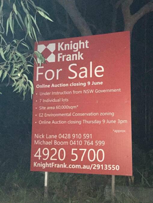 SHOCK: For sale signs were erected outside Department of Education land within the Mambo Wetlands on Saturday, which was the first indication to many residents had about the impending sale. Picture: Eileen Donaldson