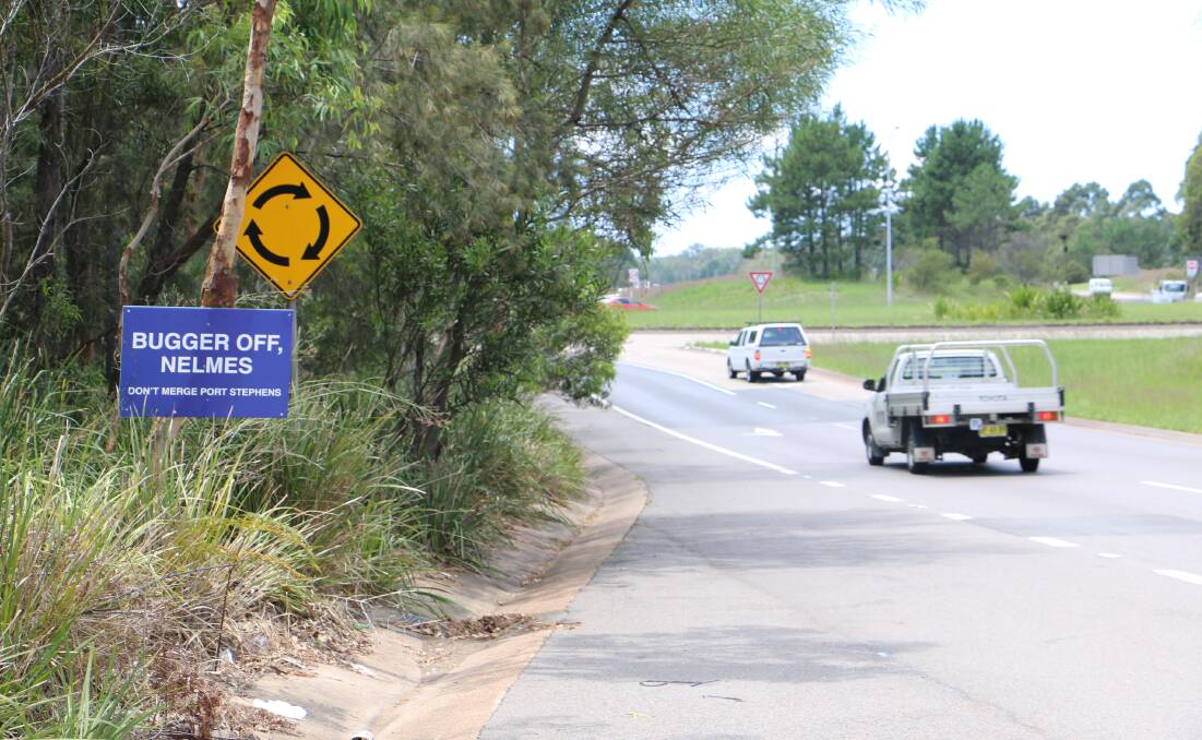 SIGN OF THE TIMES: A sign reading "Bugger off, Nelmes" was nailed to a tree at the Pacific Highway and Masonite Road roundabout at Heatherbrae. The sign has been removed since Monday.