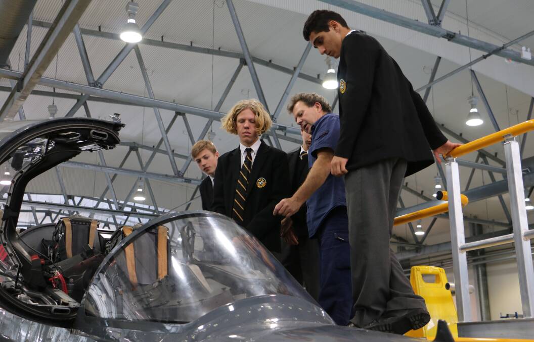 CURIOUS: St Philip's Christian College - Waratah students inspect a jet that BAE Systems Williamtown maintains. Picture: Ellie-Marie Watts