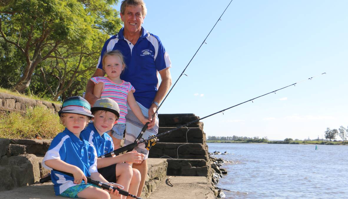 FISH FUN: Ned Hughes, 4, Zac Hughes, 6, Hallie Hughes, 2, and Junction Inn Fishing Club president Peter Hughes by the Hunter River at Raymond Terrace. Picture: Ellie-Marie Watts 