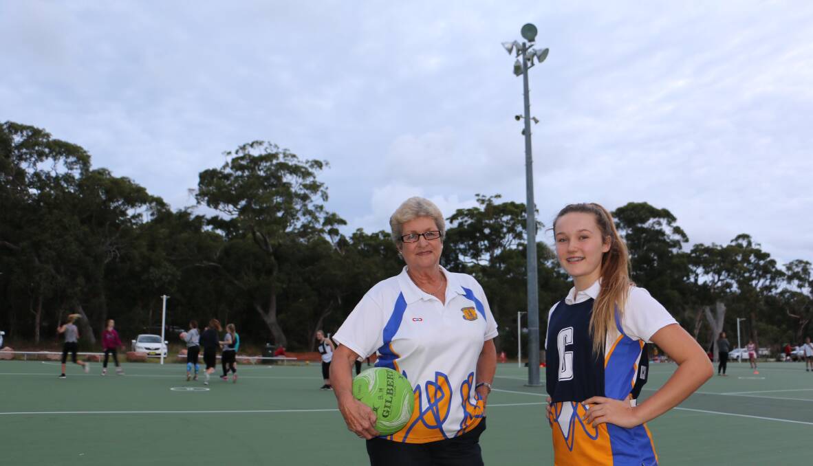 LIGHT MISSION: Nelson Bay Netball Association president Helen Scott with Salt Ash player Emily Kenny, 14, at the Tomaree Sports Complex courts. Picture: Ellie-Marie Watts